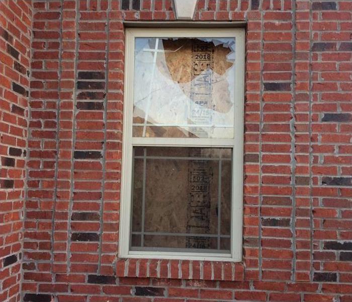 window boarded after vandalism