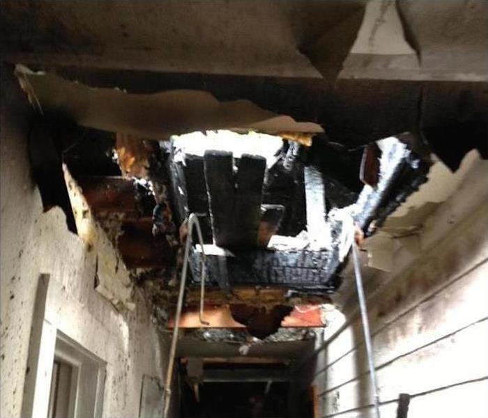 House with severe roof damage from fire
